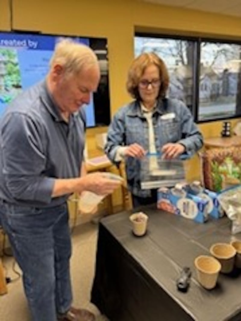 Cathy Flynn assists a participant in the University of Illinois Extension's Master Gardener Program at Oglesby Library on Wednesday, March 26.