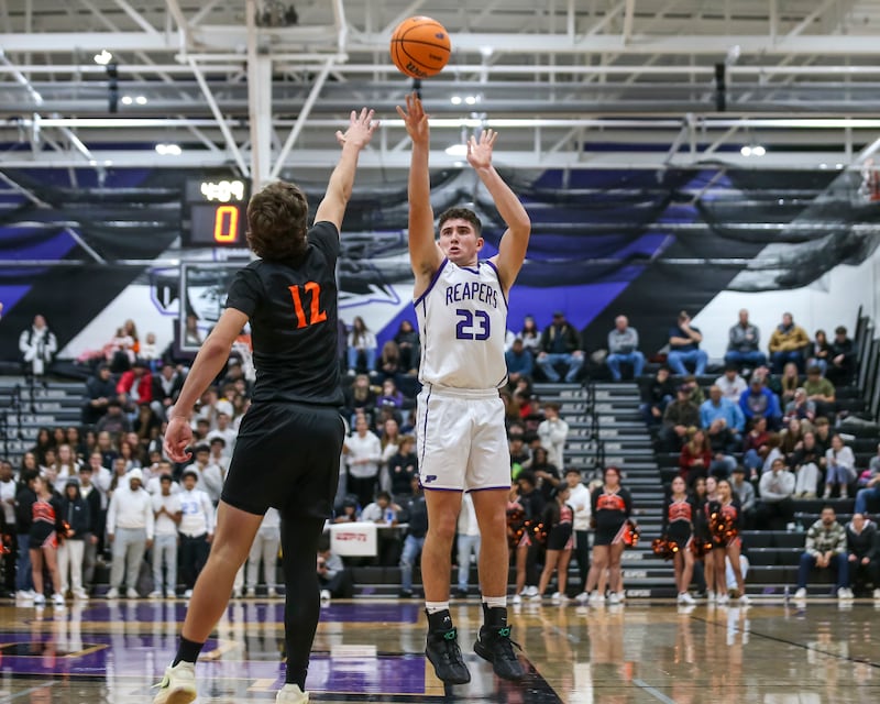 Plano's Cooper Beaty (23) shoots a jumper from the top fo the key during their basketball game between Sandwich at Plano Tuesday, Dec 9, 2025 in Plano.