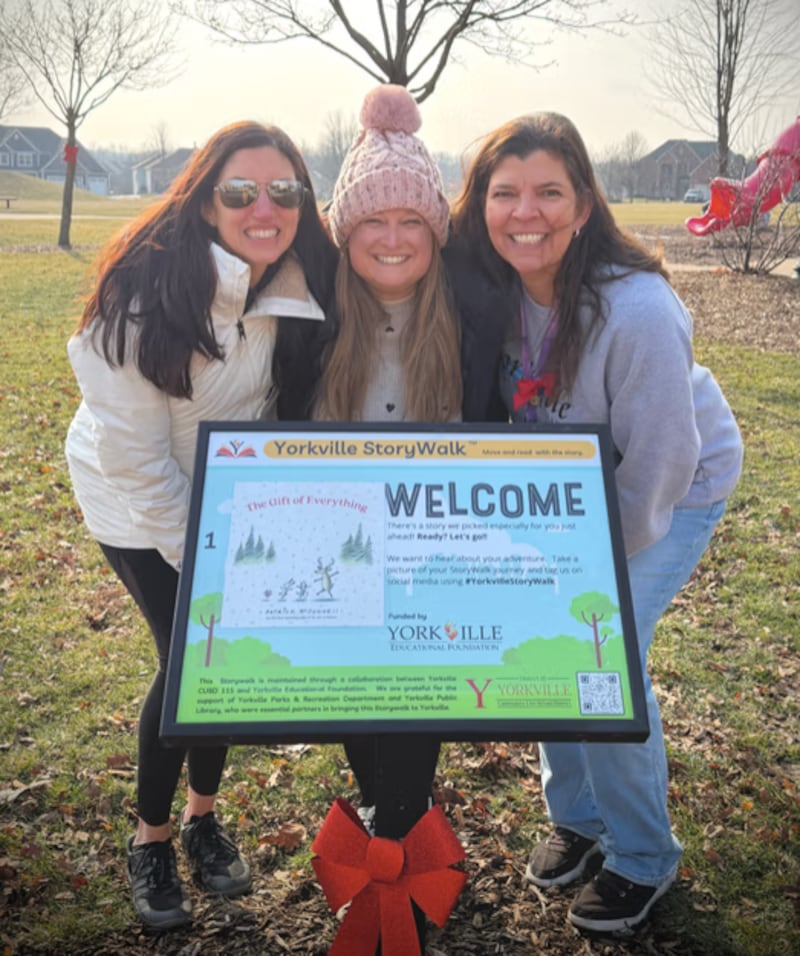 Leslie Smogor of the Yorkville Education Foundation, Steph McHugh of Yorkville School District 115, and Jennette Weiss of the Yorkville Public Library celebrate the launch of the new Yorkville Story Walk at the Junior Women’s Club Park at Heartland Circle.