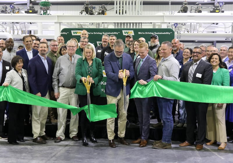 Waste Management employees and area officials cut the ribbon Tuesday, April 22, 2025, during the grand opening of the Waste Management renewable natural gas facility at the landfill in DeKalb. The facility converts collected landfill gas to lower-emission renewable natural gas which can be used to power homes and natural gas powered vehicles.
