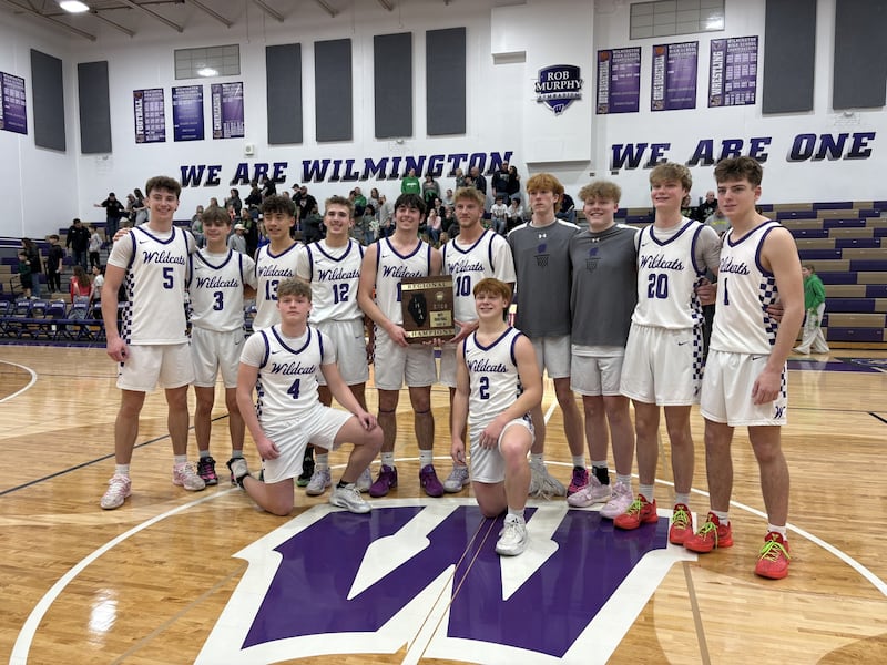 Wilmington players pose with the Class 2A regional championship plaque after a 54-43 win over Seneca on Friday, Feb. 27, at Wilmington High School.