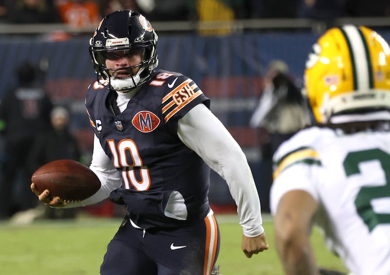 Chicago Bears quarterback Caleb Williams looks to get by Green Bay Packers safety Javon Bullard as he scrambles during their NFL Wild Card game Saturday, Jan. 10, 2026, at Soldier Field in Chicago.