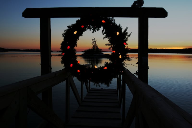 FILE - This Tuesday, Dec. 18, 2007 file photo shows a Christmas wreath decorated with lights at the end of a dock at sunset on Linekin Bay in East Boothbay, Maine. Wintertime can trigger true but transient depression in some people, a condition sometimes called Seasonal Affective Disorder. It's linked with lack of sunlight in winter and some scientists think affected people overproduce the sleep-regulating hormone melatonin. Research suggests it affects about 6 percent of the U.S. population and rates are higher in Scandinavia. But contrary to popular belief, suicides peak in springtime, not winter. No one has figured out why. (AP Photo/Pat Wellenbach)