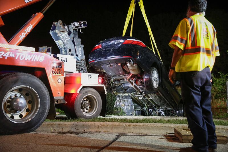 First responders remove a car from a pond in Cary on July 28, 2025. No occupants were found.