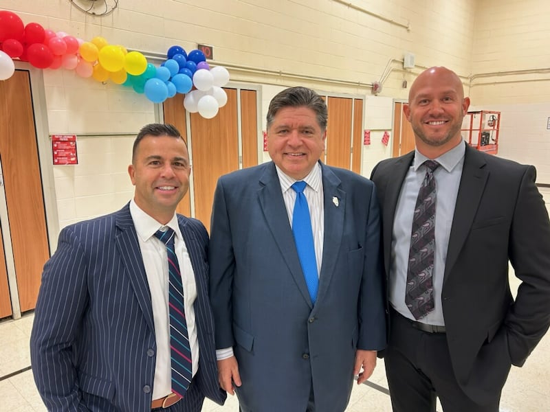 Bourbonnais Elementary Superintendent Adam Ehrman and Liberty Principal Bret Pignatiello stand with Gov. JB Pritzker on Friday, Oct. 10, 2025, at an event recognizing recipients of the Illinois Governor’s Blue Ribbon Schools. Liberty Intermediate was one of 28 schools recognized for exemplary academic achievement.
