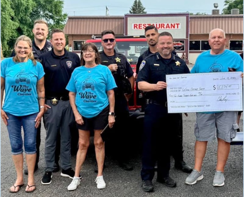 Officers of the La Salle Police Department accepting a $5,274 donation from members of The Wave of Charities, to help fund the Officer Santa Program later this year.