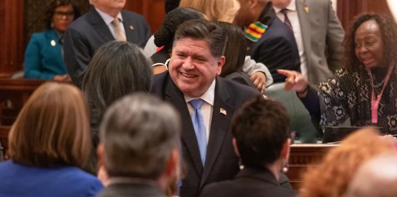 Gov. JB Pritzker enters the House chamber for his 2025 budget address.