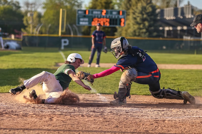 Plainfield Central's Cole Sisti (16) is tagged out at the plate during baseball game between Romeoville at Plainfield Central Tuesday, April 29, 2025 in Plainfield.