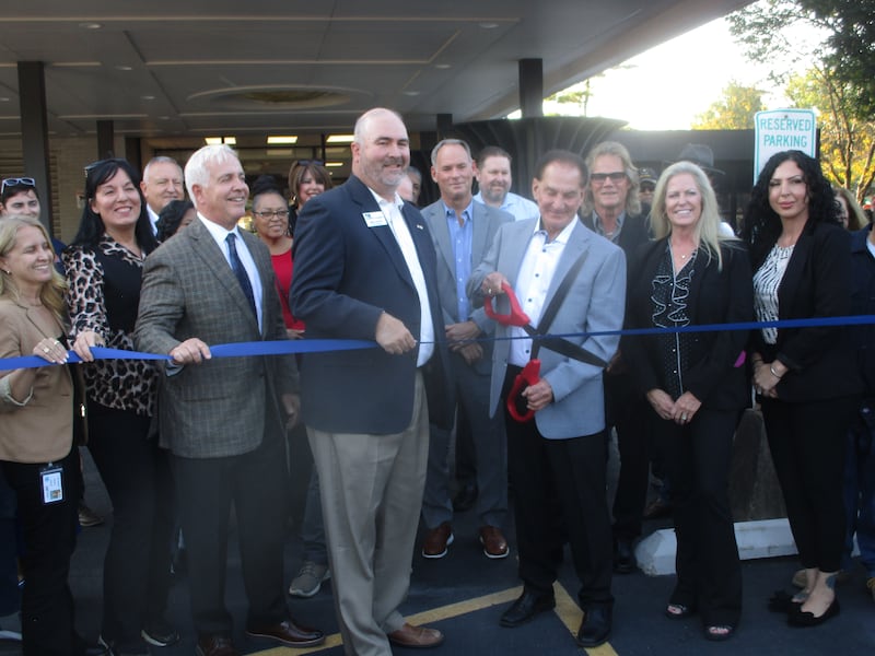 John Bays cuts the ribbon for his Bays Tower apartments on Thursday. Oct. 16, 2025