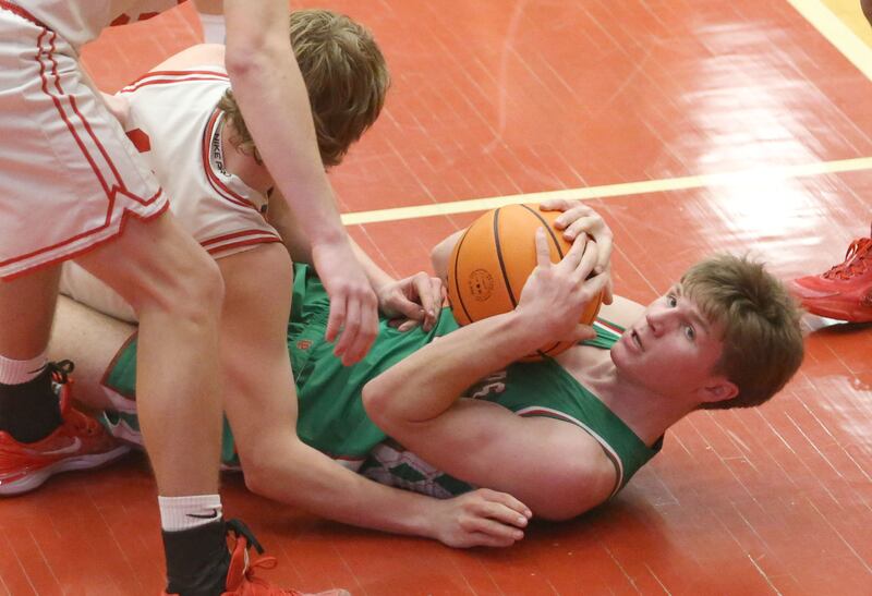 L-P's Braylin Bond holds a loose ball in the paint as Ottawa's Jack Carroll arrives late to the ball on Friday, Feb. 6, 2026 in Kingman Gymnasium at Ottawa High School.