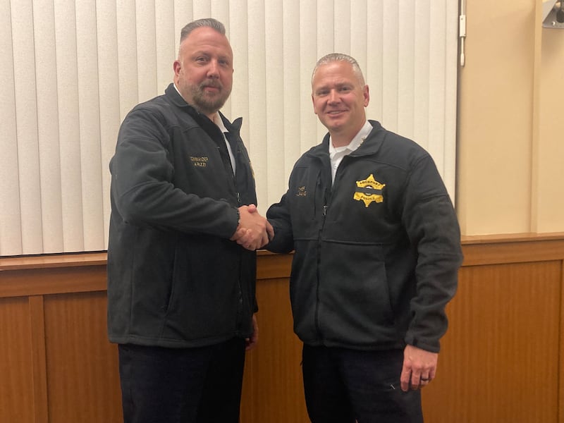 Incoming Lockport Police Chief John Arizzi shakes hands with retiring chief Rich Harang at the City Council meeting on Wednesday, June 18, 2025.