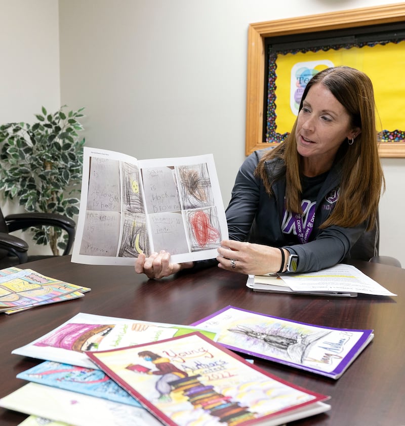 Madison School teacher Melissa Guthrie shows off some of her favorite included works in the book Tuesday, Oct. 21, 2025.