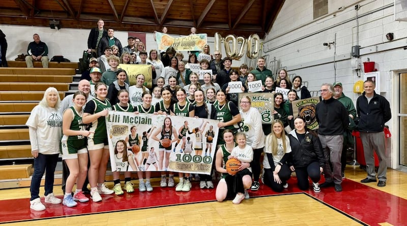 St. Bede senior Lili McClain (front) is joined by. all of her St. Bede fans to celebrate her 1,000th career point she scored in Thursday's game at Henry. She is the fifth St. Bede girl to score 1,000 points.