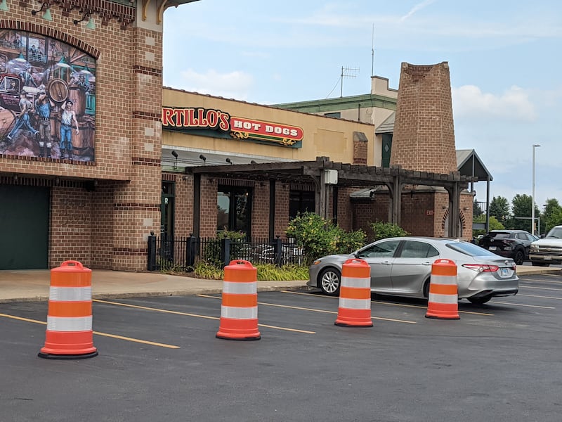 The Portillo’s restaurant in Oswego has placed white and orange construction barrels in front of its entrance after a 2-year-old boy was killed on July 30 when a car crashed into the restaurant.