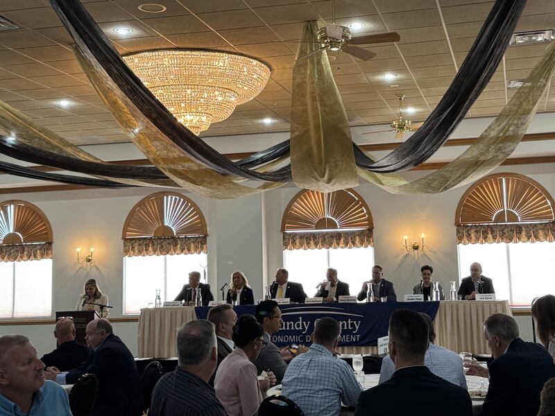 Nancy Norton, President and CEO of the Grundy Economic Development Commission (left), addresses the crowd at the annual GEDC Legislative Breakfast. Also pictures are (from left) 16th District US Rep. Darin LaHood, R-Dunlap, 38th District Ill. Senator Sue Rezin, R-Morris, 40th District Ill. Senator Patrick Joyce,, D-Essex, 53rd District Ill. Senator Chris Balkema, 106th District Ill. Rep. Jason Bunting, R-Dwight, 79th District Ill. Rep. Jackie Haas, R-Kankakee, and 75th District Ill. Rep. Jed Davis, R-Yorkville.