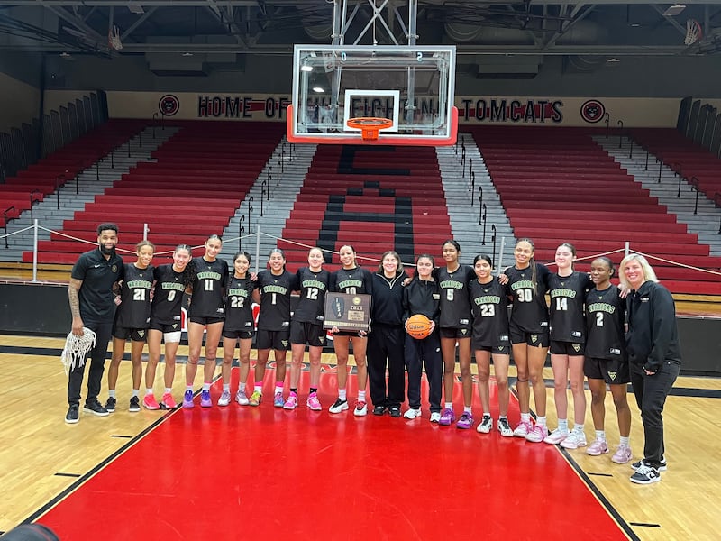 The Waubonsie Valley girls basketball team poses with the sectional plaque after beating Benet 45-37 in the Class 4A East Aurora Sectional final.
