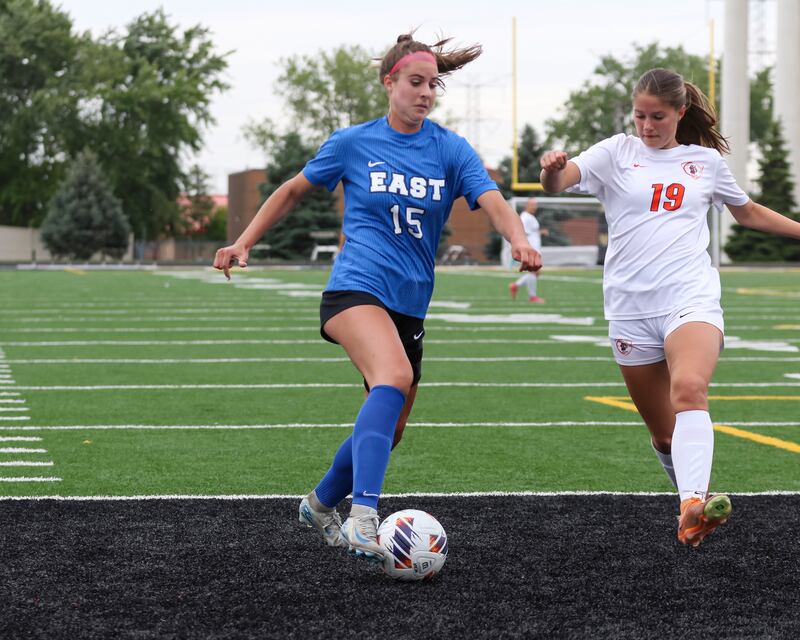 Lincoln-Way East's Ellie Feigl (15) battles Lincoln-Way West's Abigail German (19) for possession during the Class 3A Joliet West Sectional semi-final soccer match between Lincoln-Way West at Lincoln-Way East. May 27, 2025.