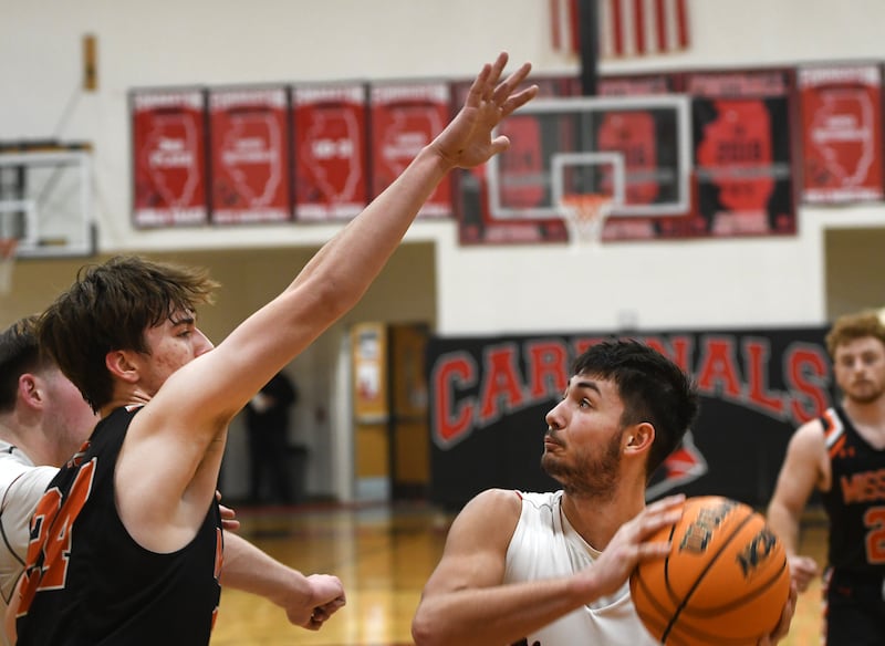 Forreston's Mickey Probst (right) looks to the basket as Milledgeville's Bryson Wiersema defends during 1A regional action at Forreston High School on Monday, Feb. 23, 2026.