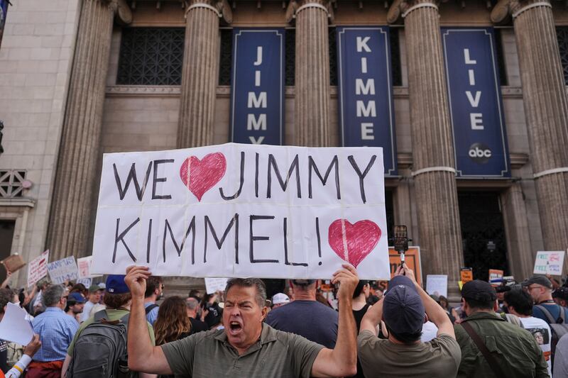 Oscar Villanueva holds a sign outside El Capitan Entertainment Centre, where the late-night show "Jimmy Kimmel Live!" is staged, Thursday, Sept. 18, 2025, in Los Angeles. (AP Photo/Jae C. Hong)
