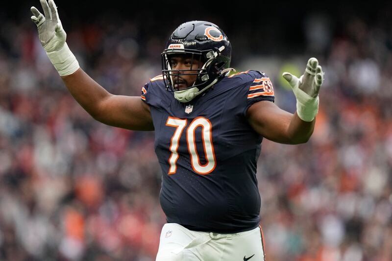 Chicago Bears offensive tackle Braxton Jones (70) celebrates after a touchdown against the Jacksonville Jaguars during an NFL football game at Tottenham Hotspur Stadium, Sunday, Oct. 13, 2024 in London. (AP Photo/Steve Luciano)