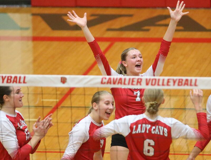 (Top) L-P's Aubrey Duttlinger celebrates with teammates (bottom from left) Drew Depenbrock, Aubrey Urbanski and Maggie Boudreau after scoring a point against Sycamore on Tuesday, Sept. 23, 2025 in Sellett Gymnasium at L-P High School.