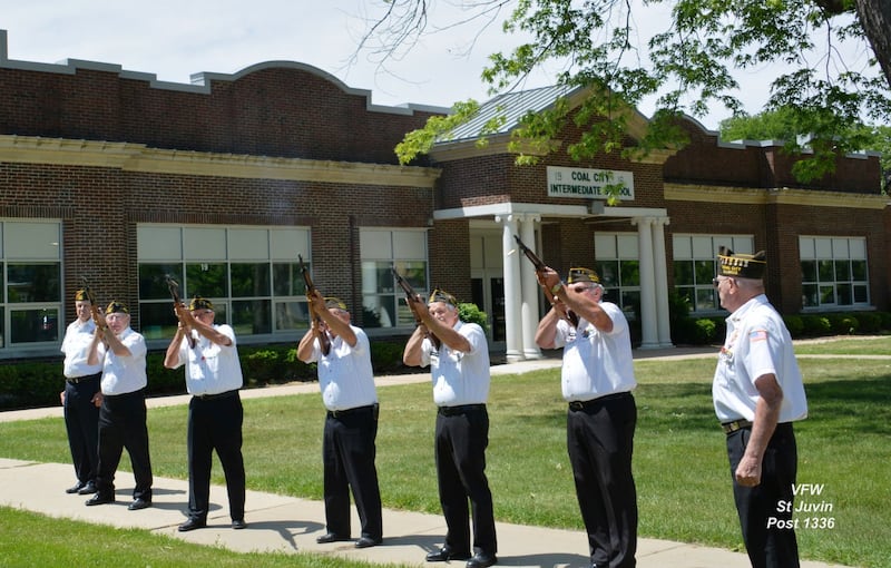 St. Juvin Post 1336 honor guard prepares to fire the ceremonial volley
