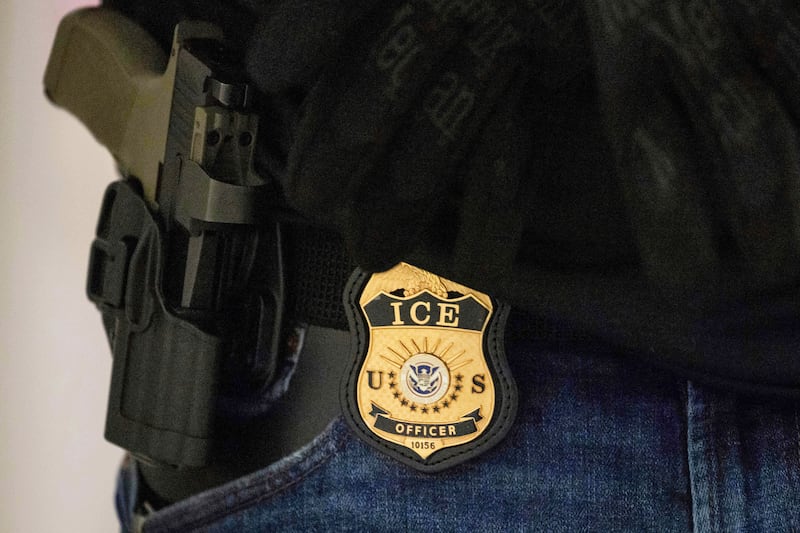 FILE - A federal agent wears an Immigration and Customs Enforcement badge at the immigration court at Jacob K. Javits Federal Building in New York, on Monday, June 9, 2025.