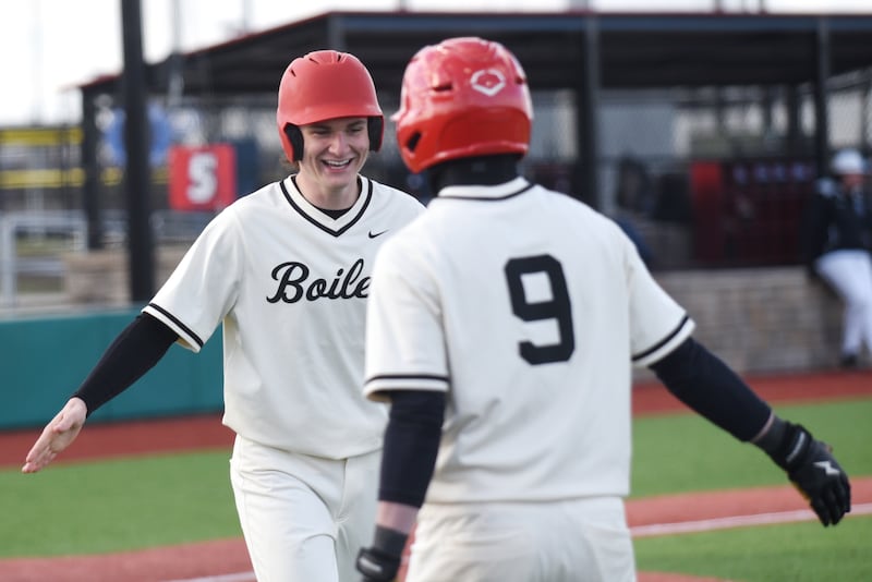 Bradley-Bourbonnais' Cooper Daugherty, left, is congratulated by teammate Keaton Allison after scoring a run during a game against Kankakee at 315 Sports Park in Bradley Friday, March 27, 2026.