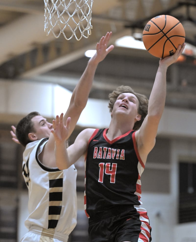 Batavia’s Brett Berggren scores against Glenbard North’s Matt Welch in a boys basketball game in Glen Ellyn on Friday, Jan. 23, 2026.