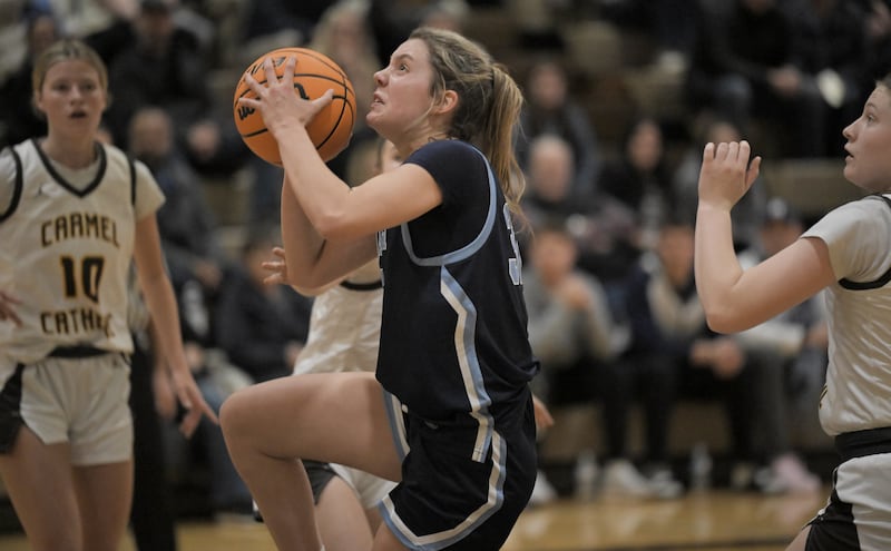 Nazareth’s Stella Sakalas drives into the Carmel defense in a girls basketball game in Mundelein on Wednesday, Jan. 7, 2026.
