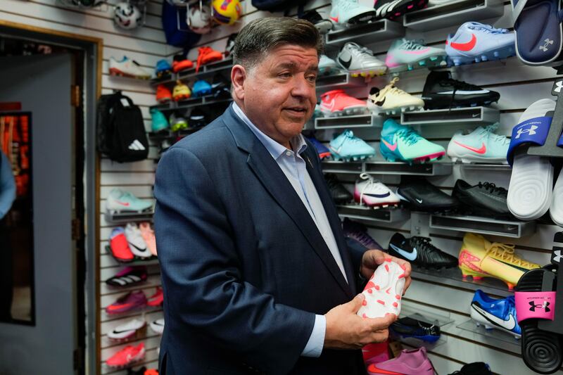 Illinois Gov. J.B. Pritzker visits with members of the family-owned soccer gear business Extreme Soccer, Thursday, Sept. 4, 2025, in Berwyn, Ill. (AP Photo/Erin Hooley)