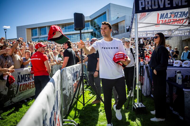 Charlie Kirk hands out hats before speaking at Utah Valley University in Orem, Utah, Wednesday, Sept. 10, 2025. (Tess Crowley/The Deseret News via AP)