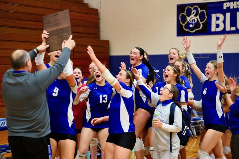 The Tigresses exuberantly take the regional championship plaque from athletic director Jeff Ohlson after defeating Sterling Newman Thursday night at Prouty Gym. It's Princeton's first regional title since 2021.