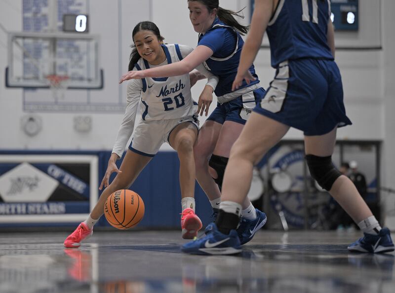 St. Charles North’s Sydney Johnson drives against Geneva’s Keira McCann in a girls basketball game in St. Charles on Thursday, Jan. 22, 2026.