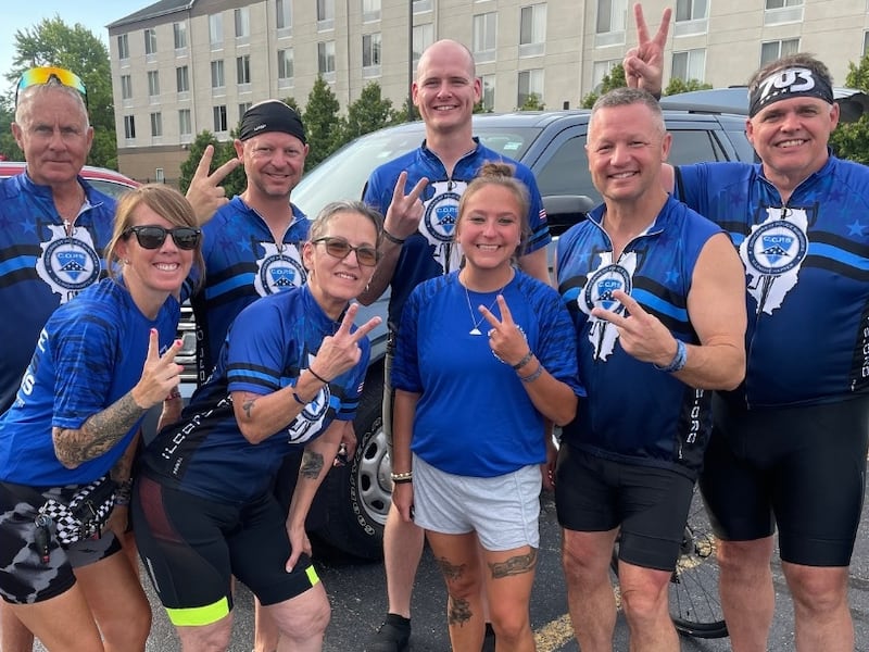 Personnel with the DeKalb County Sheriff's Office and others, including Sheriff Andy Sullivan (two from right), pose on Thursday, July 10, 2025, during the first day of an almost 400-mile bicycle ride from Champaign to Chicago for Cycle Across Illinois, a four-day charity ride honoring fallen law enforcement and supporting a nonprofit that helps their families.