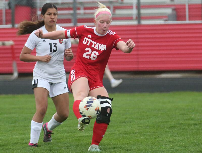Ottawa's Taylor Brandt kicks the ball ahead of L-P's Savannah Patron on Wednesday, April 30, 2025 at King Field in Ottawa.