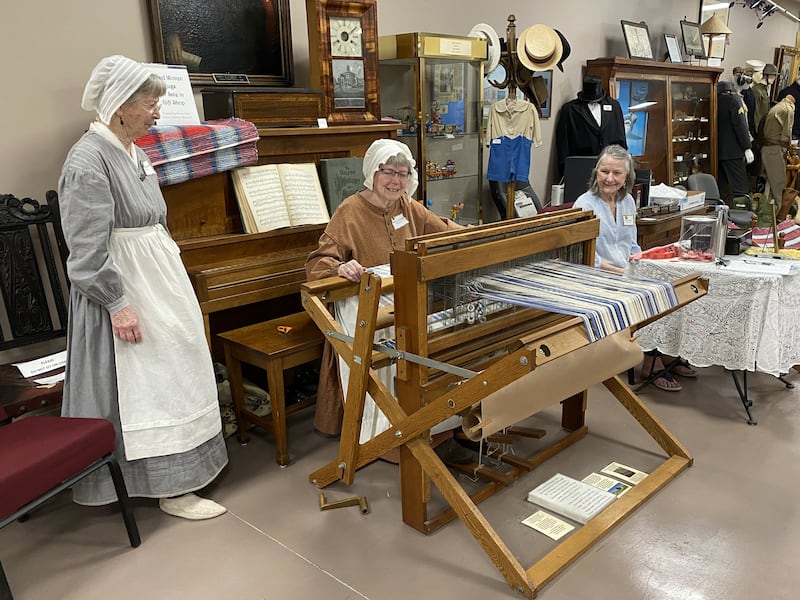 The Goose Lake Prairie Partners use the loom to weave a rug at the Grundy County Historical Museum on Sunday, May 7, 2023.