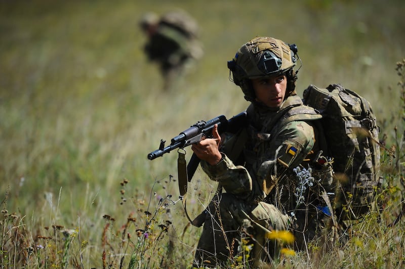 In this photo, taken on Tuesday, Aug. 19, 2025 and provided by Ukraine's 127th Separate Brigade of the Territorial Defence press service, soldiers aged 18 to 24 practice military skills on a training ground near Kharkiv, Ukraine. (Anatolii Lysianskyi/Ukraine's 127th Separate Brigade via AP)