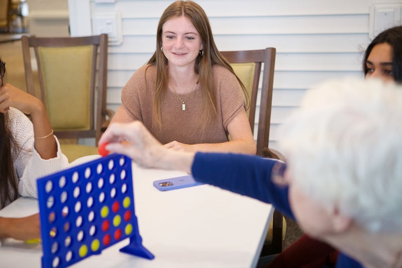 Reese Thomas looks on during Connect More Club event by District 303 students with residents at Brighton Gardens on Sunday, Sept.21,2025 in St. Charles.