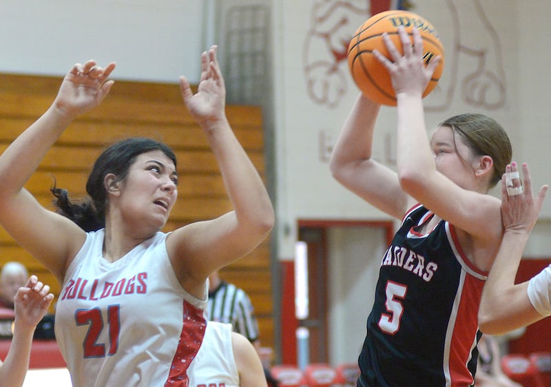 Earlville’s Bailey Miller (5) pulls down a rebound ahead of Streator’s Alexis Thomas (21) during the team's game Saturday, Jan. 10, 2026, in Streator's Pops Dale Gymnasium.