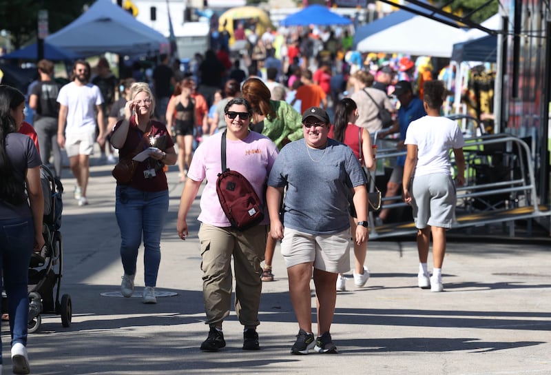 Visitors walk up North Third Street Friday, Aug. 23, 2024, during the DeKalb Corn Fest in downtown Dekalb.