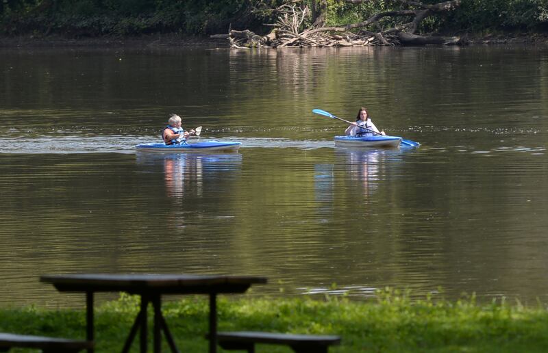 Two kayakers make their way south on the Rock River toward the Castle Rock State Park boat launch.
