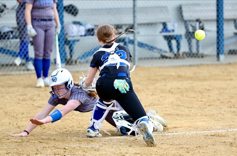 Princeton courtesy runner Payten Harden beats the throw to Newman catcher Kaylee Benyo Tuesday at Little Siberia Field in Princeton.