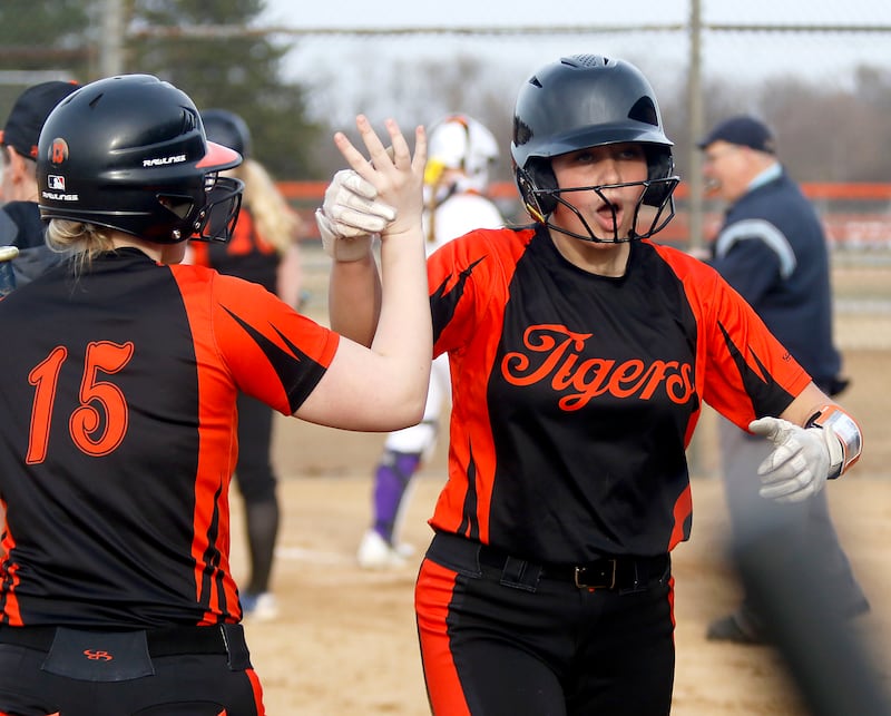 Crystal Lake Central's Oli Victorine celebrates scoring a run with teammate, Kylie Gibbons, during a nonconference softball game against Wauconda on Friday, March 20, 2026, at Crystal Lake Central High School.
