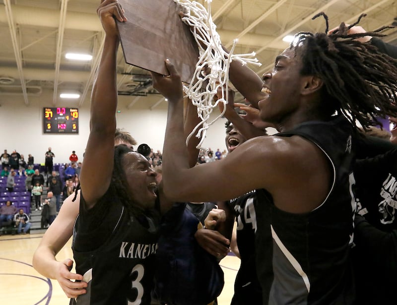 Kaneland's Marshawn Cocroft, Jeffrey Hassan and Freddy Hassan celebrate their win over Crystal Lake South in the IHSA Class 3A Rochelle Sectional championship basketball game on Friday, March 7, 2025, at Rochelle High School.