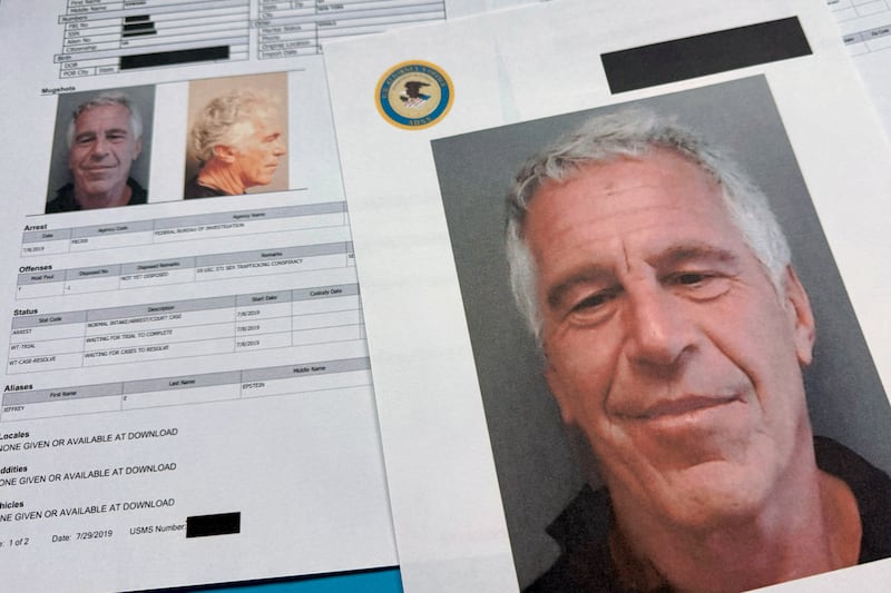 FILE - Documents that were included in the U.S. Department of Justice release of the Jeffrey Epstein files are photographed Friday, Jan. 2, 2026. (AP Photo/Jon Elswick, File)