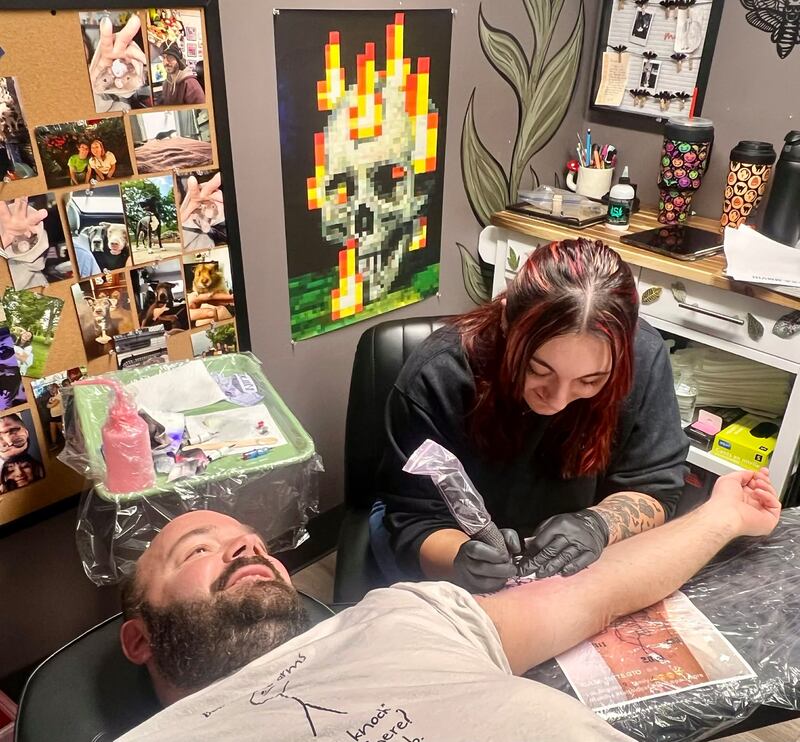 Owner Rayne Pyron works on a client at her studio, Ink and Ivy Tattoo and Piercing, at 1813 Locust St. in Sterling.
