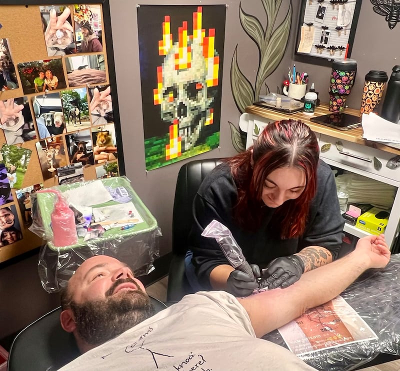 Owner Rayne Pyron works on a client at her studio, Ink and Ivy Tattoo and Piercing, at 1813 Locust St. in Sterling.