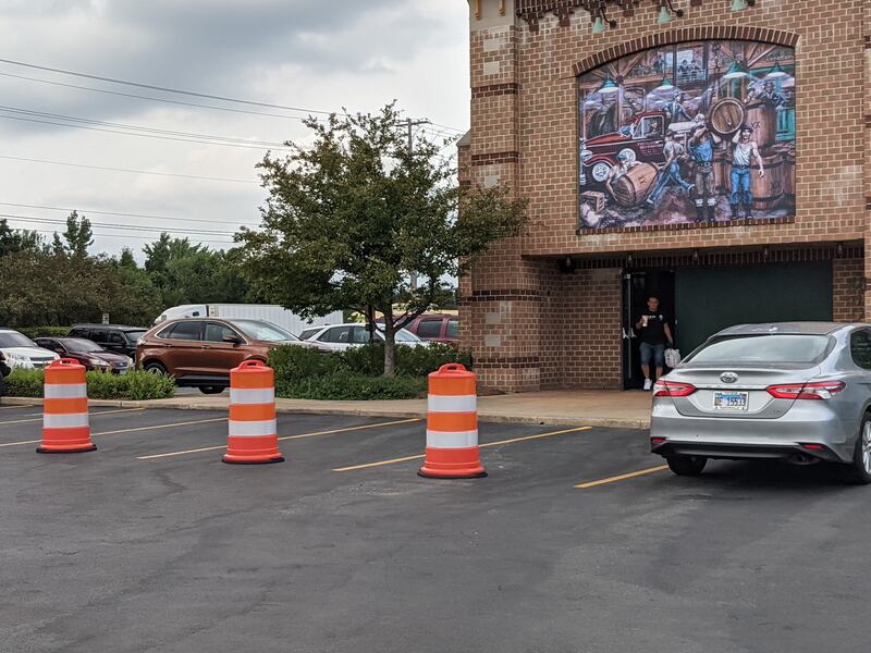 The Portillo’s restaurant in Oswego has placed white and orange construction barrels in front of its entrance after a 2-year-old boy was killed on July 30 when a car crashed into the restaurant.