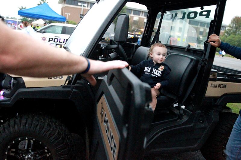 Wyatt Bolin, 2, of Geneva sits in a Kane County Sheriff utility vehicle duirng the Kane County Sheriff’s National Night Out in St. Charles on Tuesday, Aug. 6, 2024.